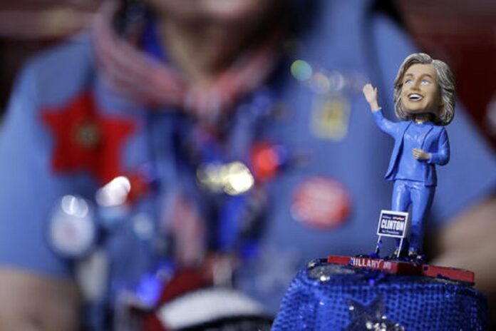 A delegate wears a hat with a bubble-head doll of Democratic Presidential candidate Sec. Hillary Clinton during the first day of the Democratic National Convention in Philadelphia , Monday, July 25, 2016. Photo: John Locher