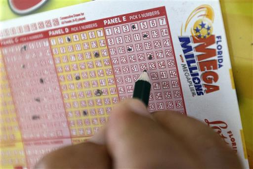 A customer fills out a Mega Millions ticket at a local grocery store, Friday, July 1, 2016, in Hialeah, Fla. Photo: Alan Diaz / Associated Press