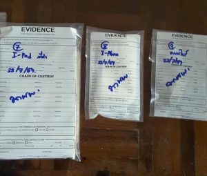 Bagged evidence taken from the family home of Andrew MacGregor Marshall Friday morning in Bangkok.