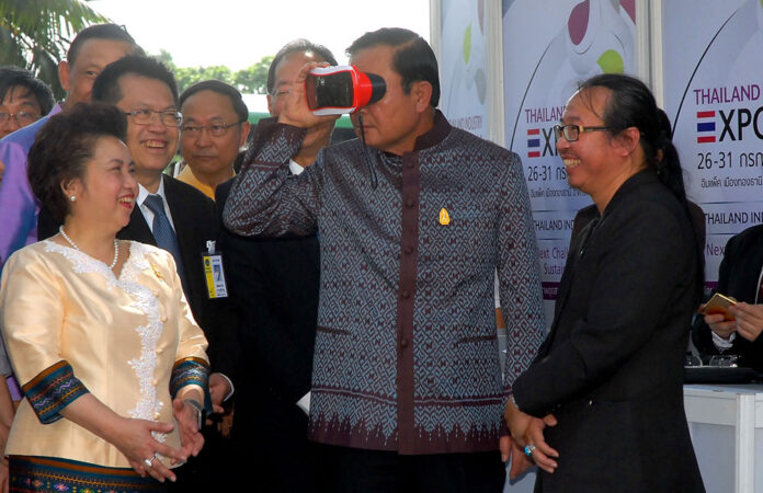 Junta chief Prayuth Chan-ocha demos 'Magic Eyes' industrial goggles at Industry Expo on Tuesday in Bangkok.