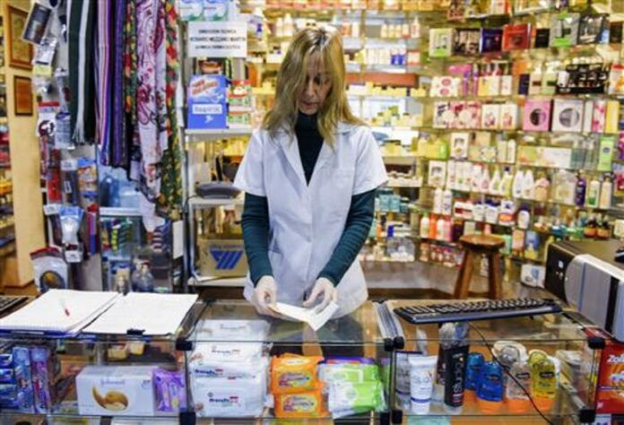 In this June 23, 2016 photo, pharmacist Rossana Rilla works at her own drugstore in downtown Montevideo, Uruguay. In her 28 years as a pharmacist, she has been beaten, dragged across the floor and threatened by thieves at gunpoint and with a grenade. Photo: Associated Press