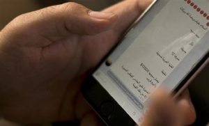 An activist looks at an Islamic State group marketplace on the encrypted app Telegram, advertising a 12-year-old Yazidi girl as a slave for the price of $12,500, in a photo taken in northern Iraq on May 22, 2016. "Peace be upon you and the mercy and blessings of God," the text reads in Arabic. "There is a female slave - Virgin - Beautiful - 12 years old - Her Arabic is weak - Clean - Her price has reached $12,500, and she will be sold soon.