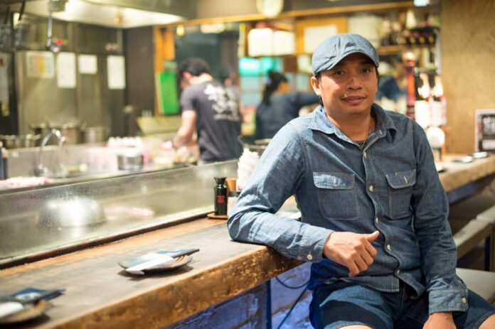 Wichian Inkraidee poses for a photo at Kacha Kacha bar. He's facing 560,000 baht in fines and a court battle for images of beer in his restaurant menu.