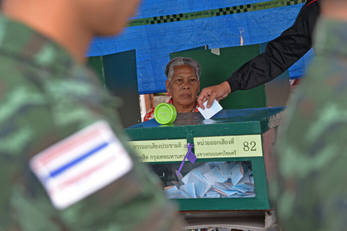 Soldiers cast their ballots Sunday at a polling station in Bangkok