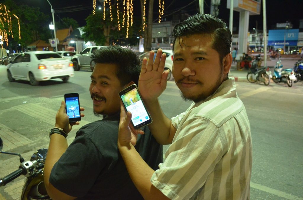 Two intrepid trainers in Korat park their motorbike Monday before hunting Pokemon.