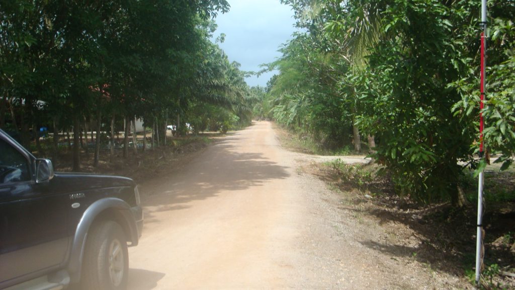 Workers on Tuesday compacted the earth along the dirt road leading to the home of Olympic medalist Sopita Tanasan in Chumphon province. 