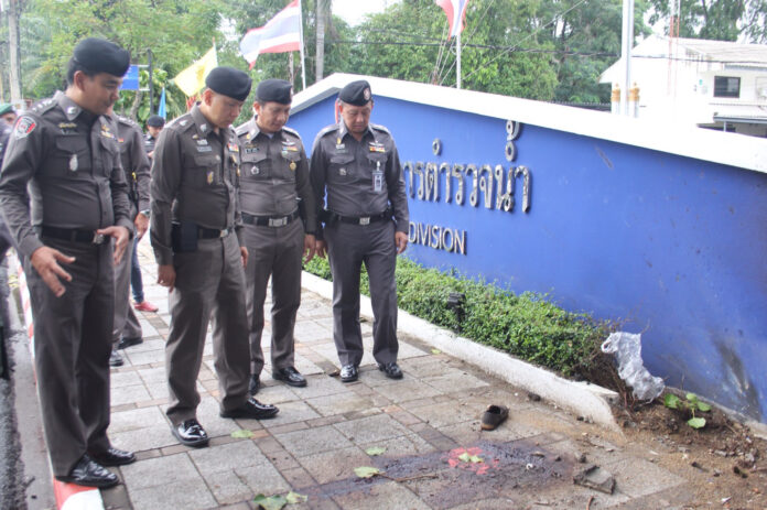 Police officers on Friday inspect the scene of the bomb attack in Surat Thani province