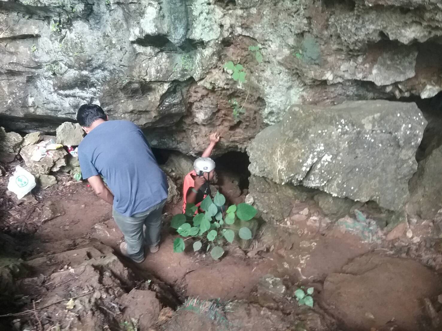 Search parties on Friday inspect one of many caves in the Tham Luang - Khun Nam Nang Non forest park, where a tourist went missing.