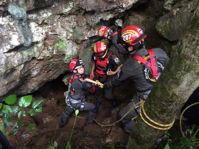 Search parties on Sunday inspect one of many caves in the Tham Luang - Khun Nam Nang Non forest park, where a tourist went missing.