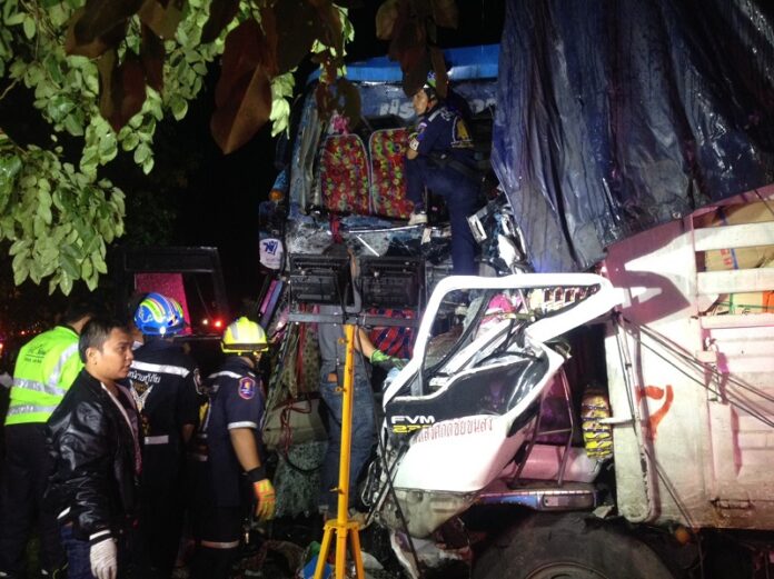 Emergency workers search the wreckage of a bus and 10-wheeler which collided on Mittraphap Road in northeastern Thailand early Friday morning.