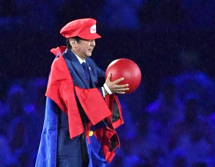 In this Sunday, Aug. 21, 2016, file photo, Japanese Prime Minister Shinzo Abe appears as the Nintendo game character Super Mario during the closing ceremony at the 2016 Summer Olympics in Rio de Janeiro, Brazil. Abe's brief but show-stopping appearance as Super Mario offered a glimpse at Tokyo's plans for the 2020 games. (Yu Nakajima/Kyodo News via AP, File)