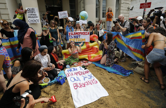 'No to Islamophobia, yes to Burkinis,' reads the blanket spread by activists outside the French embassy in London during the