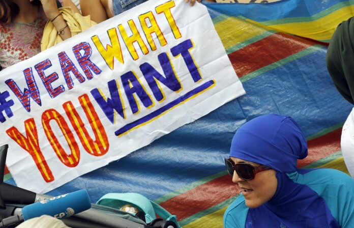 An activist protests outside the French embassy during, the