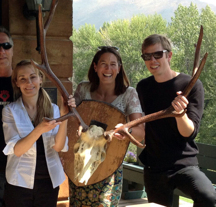 Anita Thompson, left, is joined by Library Executive Director Jenny Emery Davidson, middle, and Program Manager Scott Burton as they pose with trophy antlers while returning them to the former home of writer Ernest Hemingway on Aug. 5 in Ketchum, Idaho. Photo: Christina Jensen / The Community Library / Associated Press