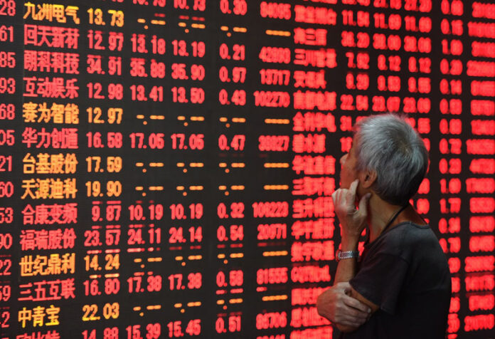 An investor stares at a stock price board at a stock trading hall in 2016 in Hangzhou, capital of east China's Zhejiang Province. Photo: Long Wei / Associated Press