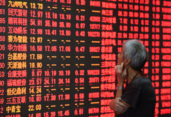 An investor stares at a stock price board at a stock trading hall in 2016 in Hangzhou, capital of east China's Zhejiang Province. Photo: Long Wei / Associated Press An investor stares at a stock price board at a stock trading hall in 2016 in Hangzhou, capital of east China's Zhejiang Province. Photo: Long Wei / Associated Press