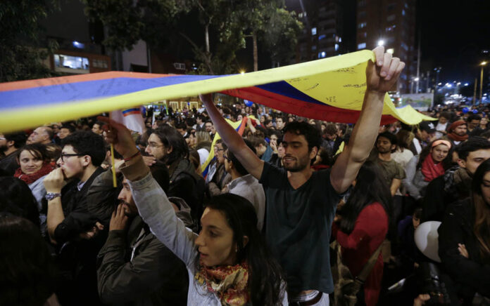 People celebrate the announcement Wednesday from Havana, Cuba, that delegates of Colombia's government and leaders of the Revolutionary Armed Forces of Colombia reached a peace accord to end their half-century civil war Colombia. Photo: Fernando Vergara / Associated Press