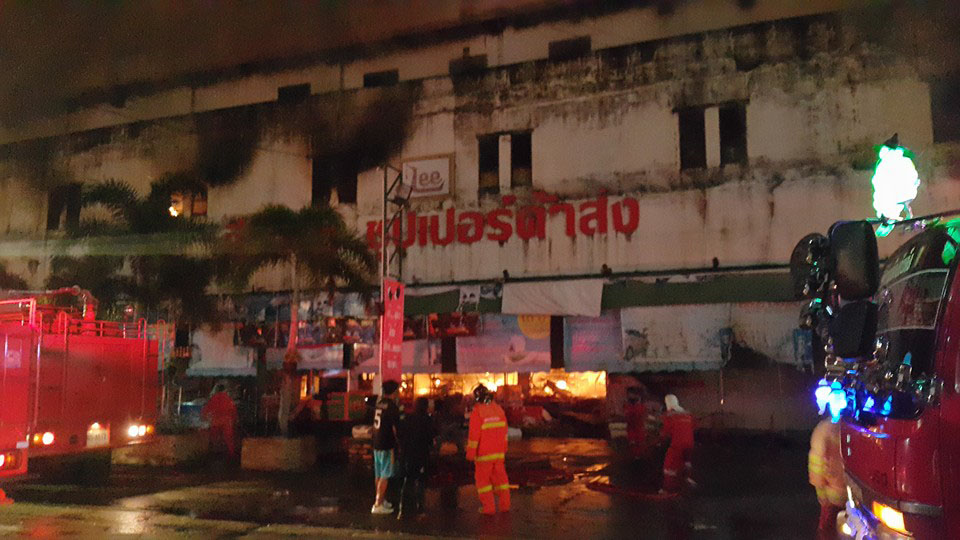 A fire at 'Lee Mart' burns early Fridiay morning in Trang province, where a deadly bombing hit the night before.