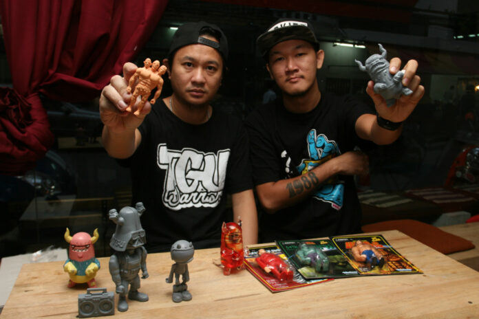 Artists Chaiwat Sermsutee-a-nuwat aka Tabun, at left, and Treetana Veeraprapan aka Tabuki Master are serious about their toys.