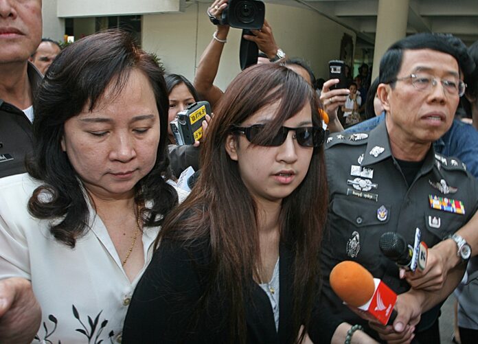 Orachorn ‘Praewa’ Thephasadin Na Ayudhya turns herself in at Metropolitan Police Bureau headquarters Jan. 5, 2011, in Bangkok.