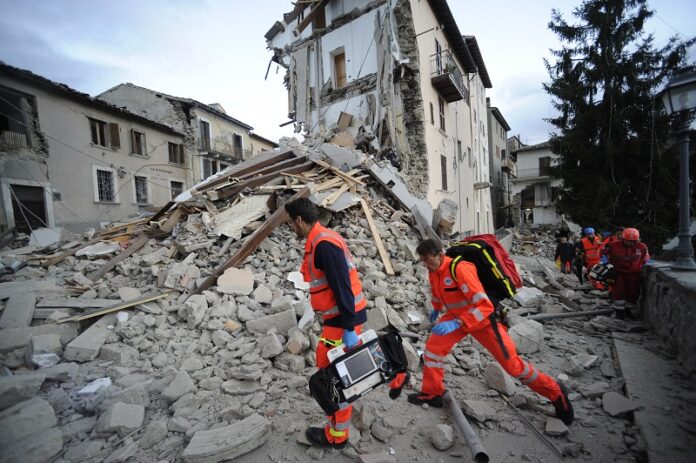Rescuers search a crumbled building in Arcuata del Tronto, central Italy where a 6.1 earthquake struck on Wednesday. Photo: Sandro Perozzi / Associated Press
