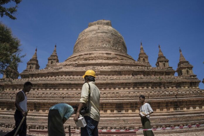 Workers set the security line around the earthquake-damaged Sitanagyi Pagoda on Thursday in Bagan, Myanmar. Photo: Hkun Lat