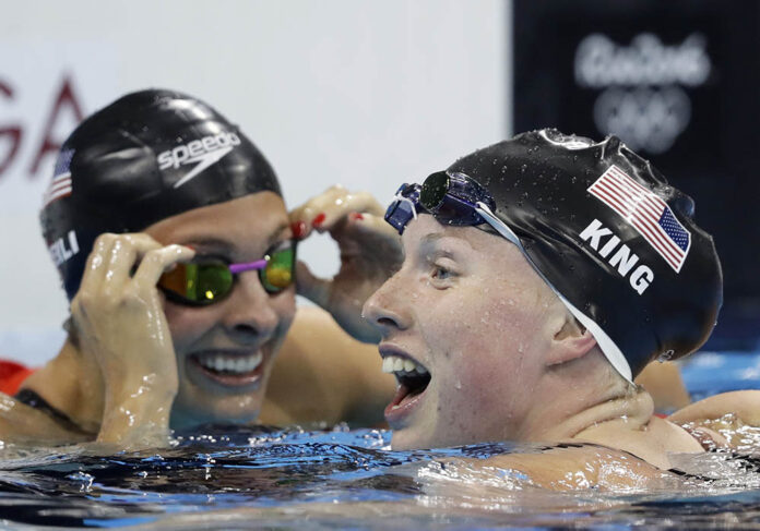 United States' Katie Meili, left, congratulates teammate Lilly King as she celebrates winning the gold medal in the women's 100-meter breaststroke final during the swimming competitions at the 2016 Summer Olympics on Monday in Rio. Photo: Michael Sohn / Associated Press