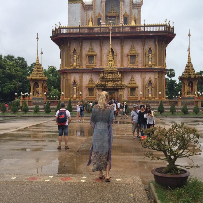 This photo of female tourist in a long, light dress rendered translucent when it became wet was taken at a landmark Phuket temple, Wat Chalong. It was widely shared for public criticism on Wednesday.