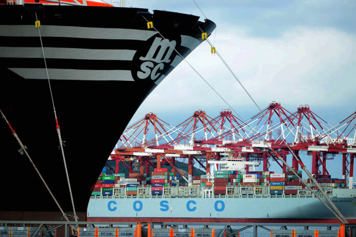 Container ships are docked at a port in Qingdao in eastern China's Shandong province Monday. Photo: Chinatopix / Associate Press