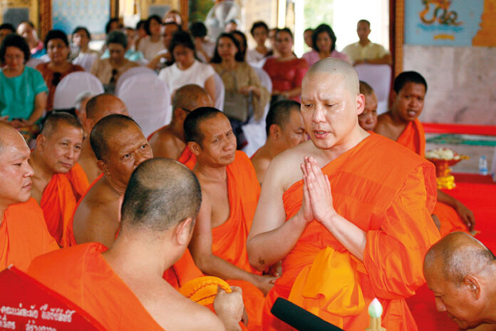 Jenphop Viraporn is ordained as a monk in a ceremony on May 9 at Wat Soontorn Thamtan in Bangkok. He left the monkhood several weeks later.