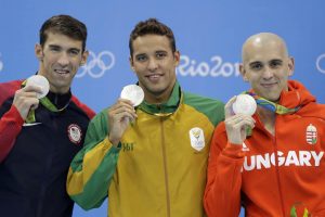 Silver medal winners Michael Phelps, South Africa's Chad Le Clos and Hungary's Laszlo Cseh hold up their medals in the men's 100-meter butterfly medals ceremony during the swimming competitions at the 2016 Summer Olympics, Friday, Aug. 12, 2016, in Rio de Janeiro, Brazil. Photo: Michael Sohn / Associated Press