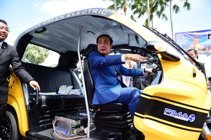 Junta leader and Prime Minister Prayuth Chan-ocha rides in an electric vehicle Wednesday at Government House in Bangkok.