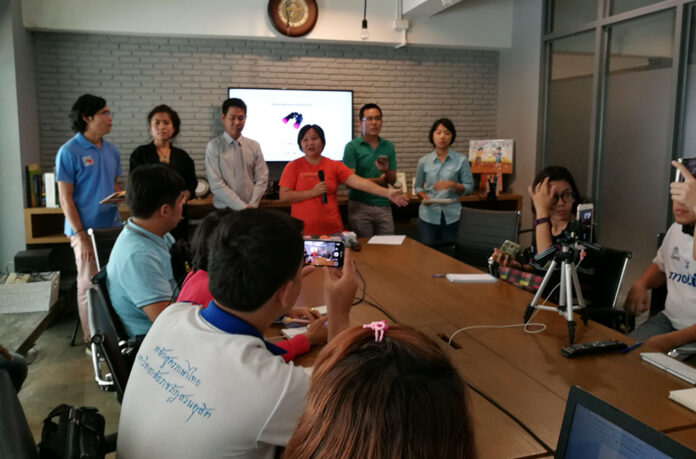 Chiranuch Premchaiporn of Prachatai news, in orange, speaks Monday in Bangkok at a meeting announcing the establishment of the Referendum Watch Network to monitor the Aug. 7 referendum.