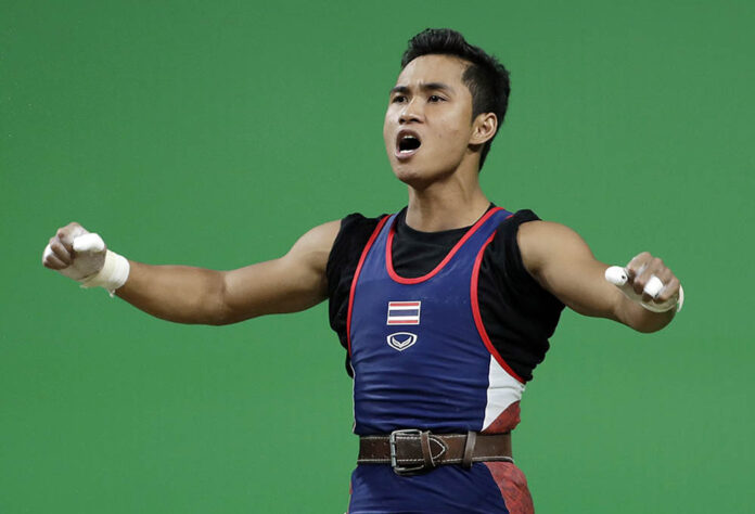 Sinphet Kruaithong, of Thailand, celebrates a successful lift in the men's 56kg weightlifting competition at the 2016 Summer Olympics on Sunday in Rio de Janeiro. Photo: Mike Groll / Associated Press
