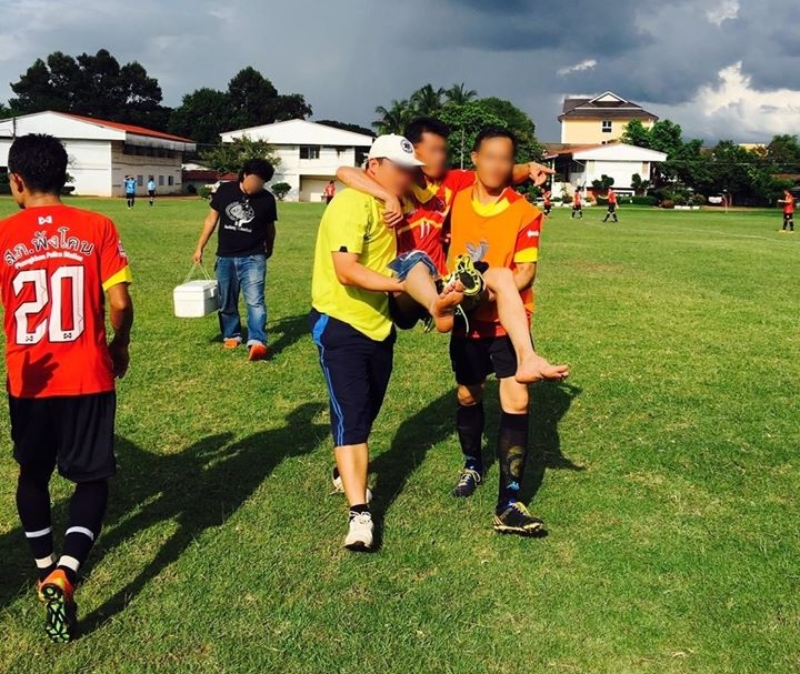 One police officer appears to be carried away from an inter-departmental football match Wednesday in Sakon Nakhon province.