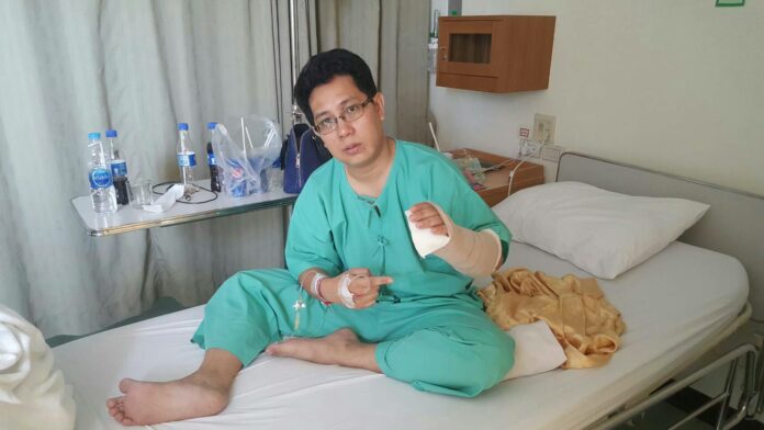 Nuttawut Nuanjun, 33, rehabilitating yesterday after a swordsman attacked him Monday.