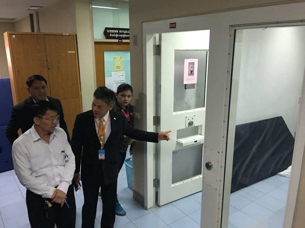Officials lead media on a tour of the detention room at DSI headquarters where the agency claimed Thawatchai Anukul hanged himself the day earlier.