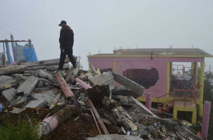 A security officer on Aug. 30 walks atop the ruins of what used to be a resort on Phu Tab Boek mountain in Phetchabun province.
