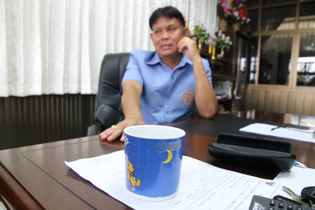 School administration on Tuesday shows reporters the coffee mug thrown by Paithoon Klaengkrathok.