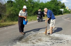 Gowan and the local volunteer group fixing potholes Sunday.