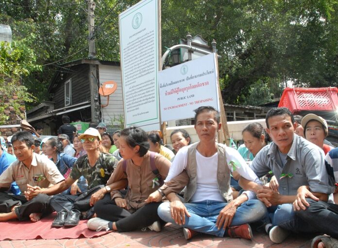 Pom Mahakan residents block an entrance to their community Wednesday morning in Bangkok.