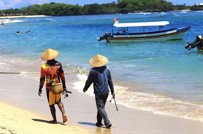 Residents walk on Nusa Dua Beach in 2015 in Bali, Indonesia. Photo: Thomas Depenbusch / Flickr