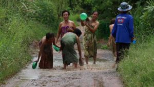 Locals in Khon Kaen bathe in potholes to protest for better roads.