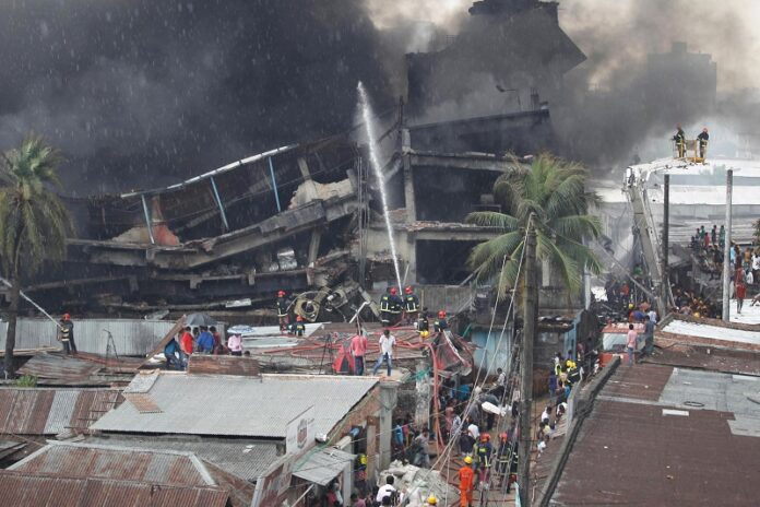 Firefighters and local people work together to put out the fire on Saturday at a packaging factory in Tongi industy area outside Dhaka, Bangladesh. Photo: A. M. Ahad / Associated Press