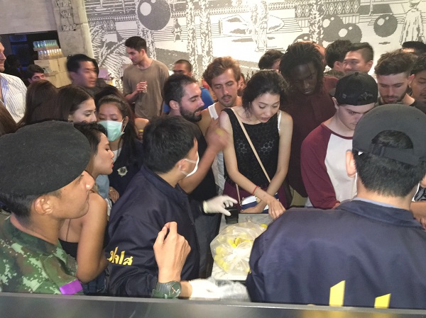 Guests at Beam, a popular electronic dance music club in Bangkok’s Thonglor area, present urine to narcotics officers early Sunday morning.