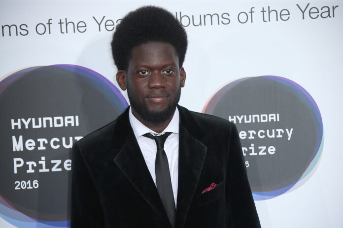 Singer Michael Kiwanuka poses for photographers upon arrival at the Mercury Prize Albums of the Year event in London. (Photo by Joel Ryan / AP)