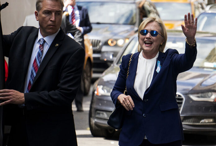 U.S. Democratic presidential candidate Hillary Clinton waves as she walks from her daughter's apartment building Sunday in New York. Photo: Craig Ruttle / Associated Press