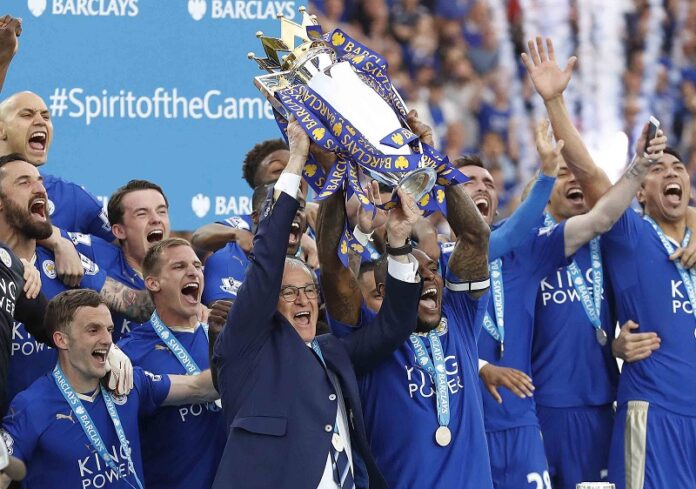 Leicester's team manager Claudio Ranieri and player Wes Morgan lift the trophy as Leicester City celebrate becoming the English Premier League soccer champions last May at the King Power stadium in Leicester, England. Photo: Matt Dunham / Associated Press