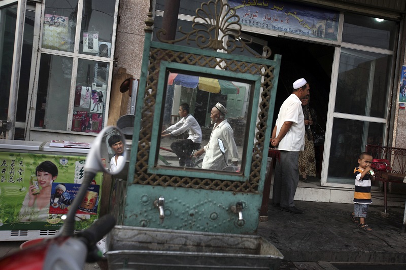Uighurs are seen outside a restaurant in 2008 in China's western Xinjiang province. Photo: Ng Han Guan / Associated Press