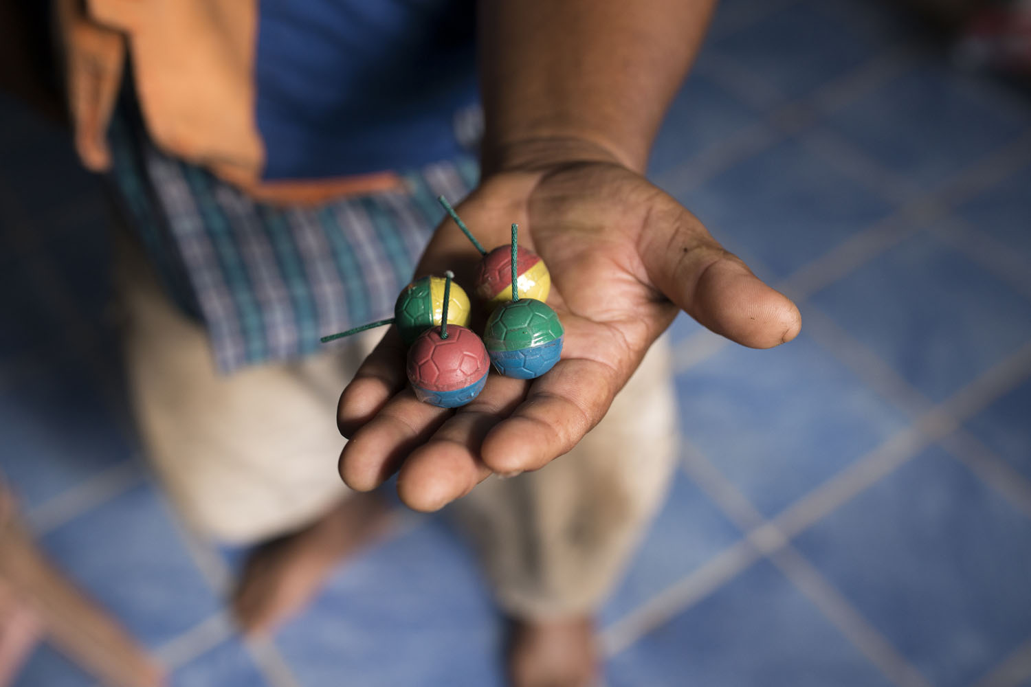 A wildlife volunteer displays the small but extremely loud fireworks used to scare off elephants in the event of an encounter. Many villagers in Kaeng Hang Meao choose instead to use pots and pans to disperse the animals.